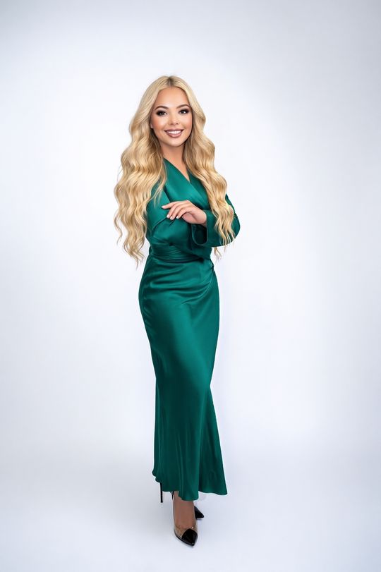 Marsha Bagmeijer, serial entrepreneur and AI automation expert, in a green dress